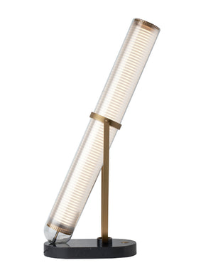 Table lamp. Made up of a marble and aluminum base, and a borosilicate glass tube. By confronting timeless materials, and a poetic 