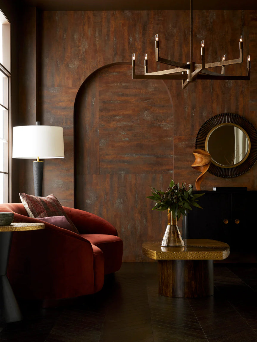 Modern living room with red sofa, wooden coffee table, and decorative wall light fixture.