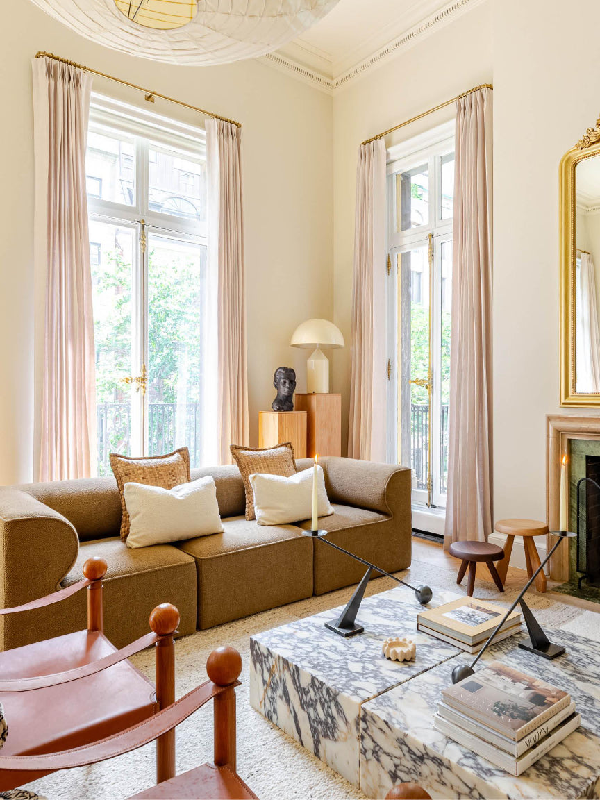 Living room with beige sofa, coffee table, and decorative items.