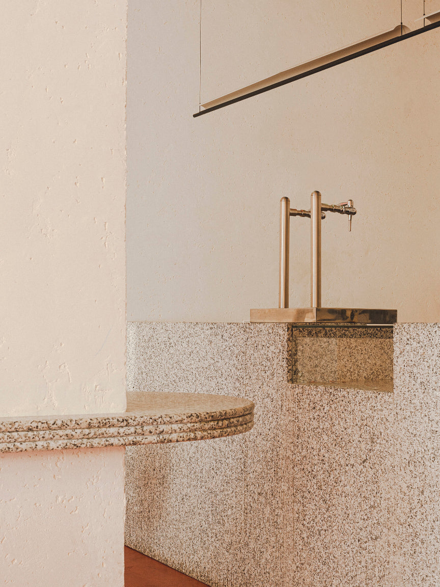 Bathroom with a modern vanity and gold faucet - Casa Neutrale