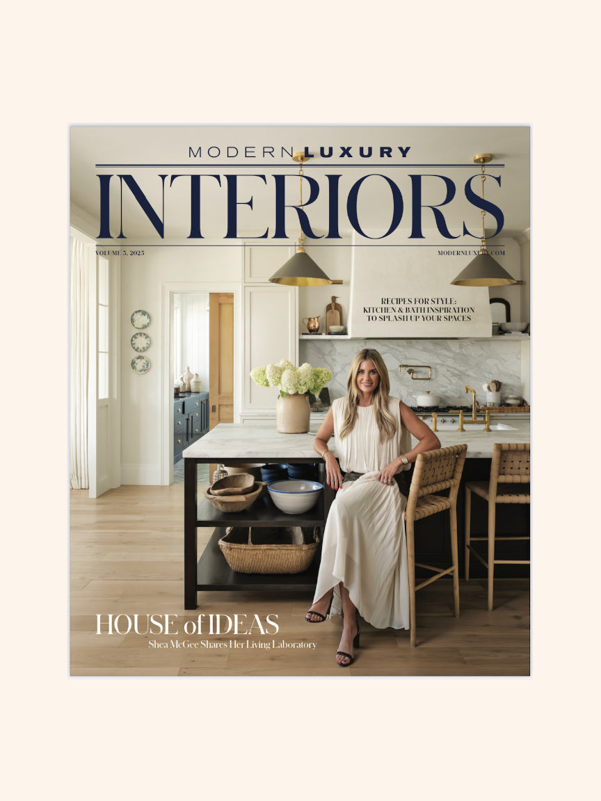 Cover of 'Modern Luxury Interiors' magazine featuring a woman in a kitchen.