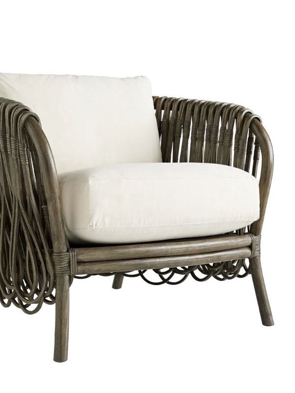 Wicker chair with white cushion on a white background