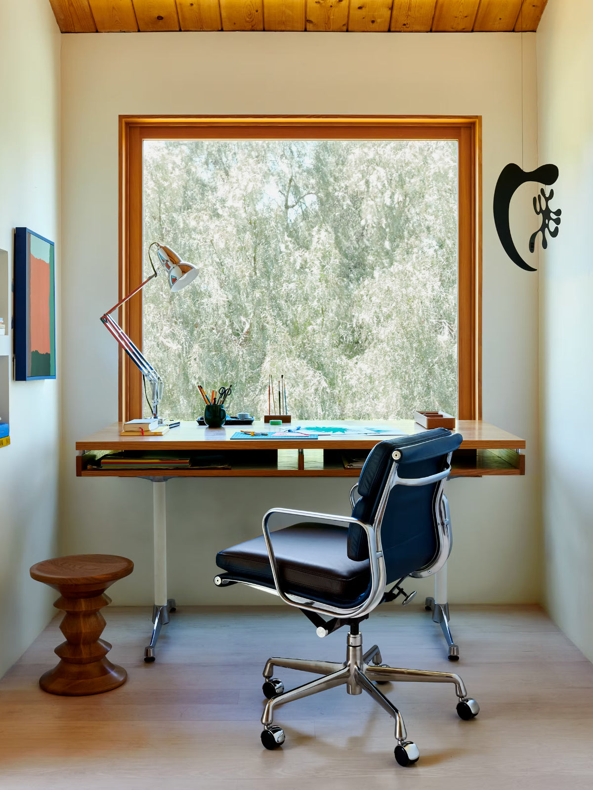Modern home office with a desk, office chair by Herman Miller.