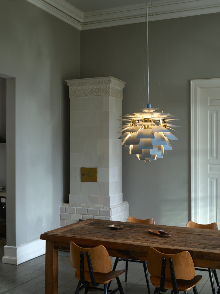 Marset chandelier in dining room with wooden table and chairs, modern chandelier, and gray walls.
