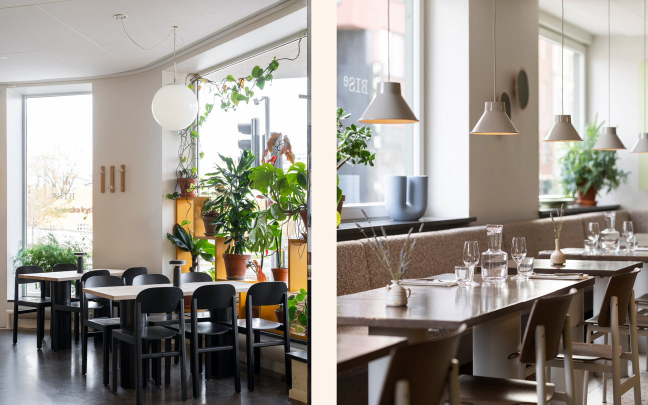 Modern restaurant interior with tables, chairs, and plants.