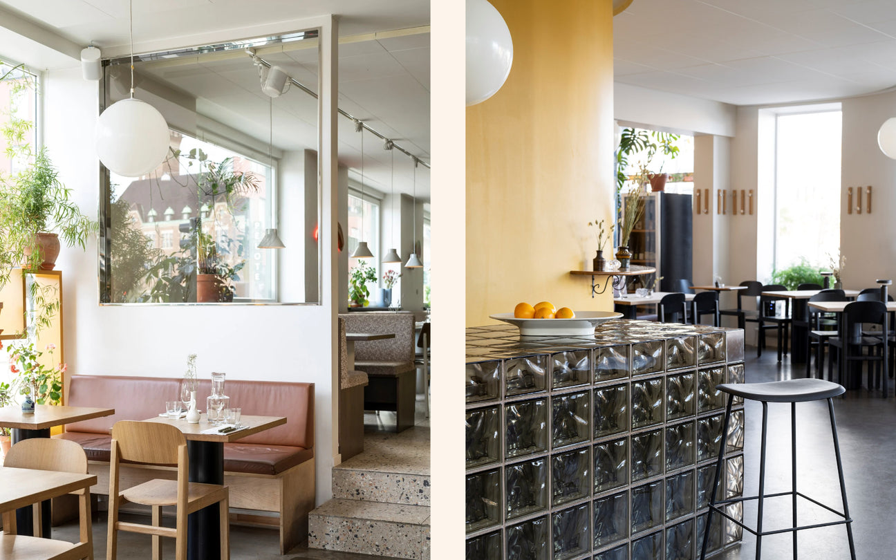 Modern restaurant interior with glass block wall and wooden furniture.