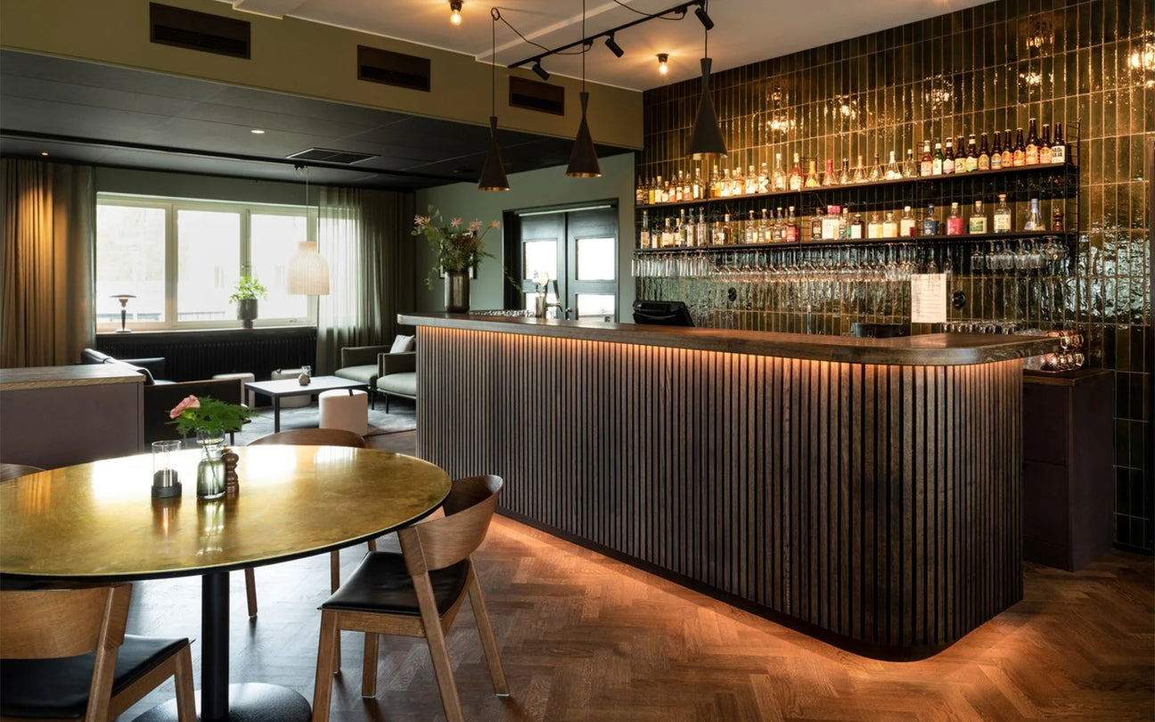 Modern restaurant interior with a bar counter and seating area.
