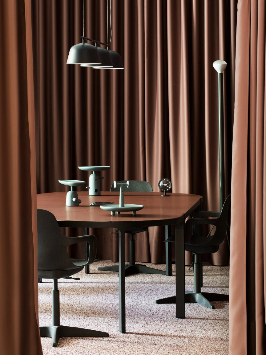 Dining area with a table and chairs in front of brown curtains