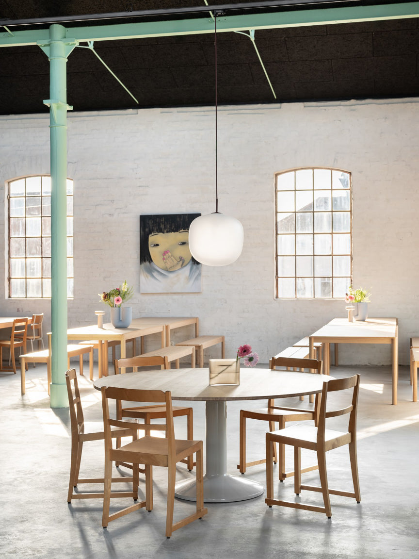 Modern interior with wooden tables and chairs in a well-lit room.